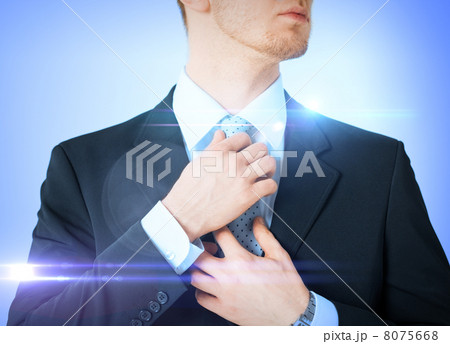man adjusting his tie man adjusting his tie 8075668