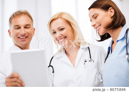 doctors looking at tablet pc 8075896