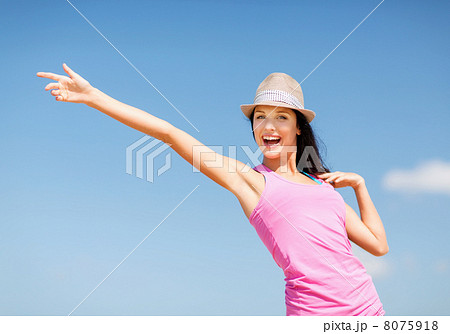 girl in hat showing direction on the beach girl in hat showing direction on the beach 8075918