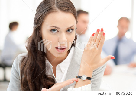 businesswoman pointing at her watch businesswoman pointing at her watch 8075920