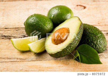 avocado and limes on wooden background avocado and limes on wooden background 8075972