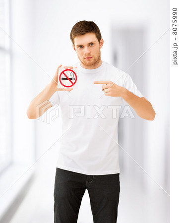 young man pointing at no smoking sign 8075990