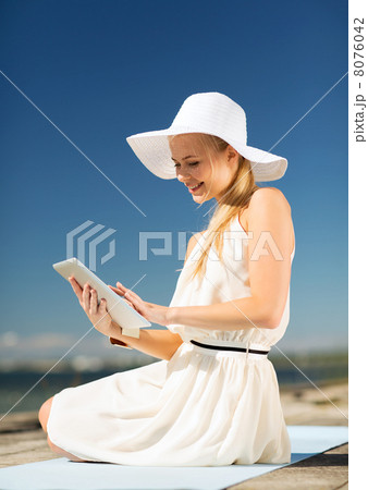 beautiful woman in a dress with tablet pc 8076042