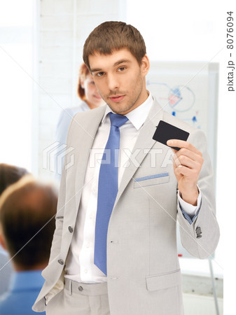 businessman showing credit card in office 8076094