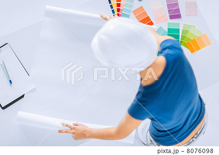 woman with color samples and blueprint 8076098