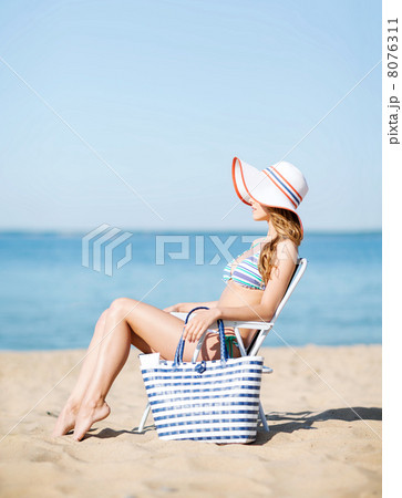 girl sunbathing on the beach chair girl sunbathing on the beach chair 8076311