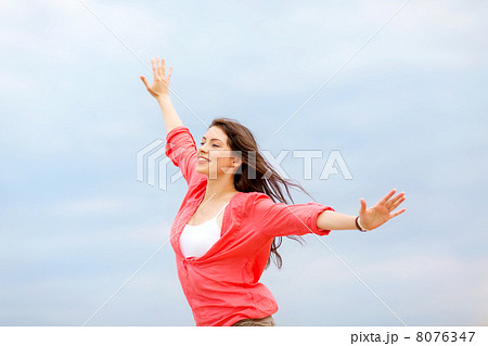 girl with hands up on the beach 8076347