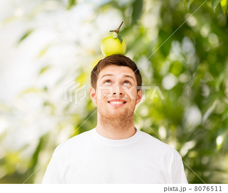 man with green apple on his head 8076511