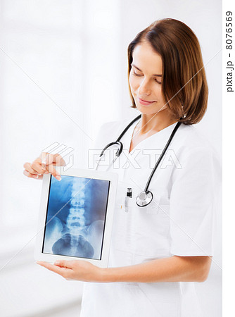 female doctor with x-ray on tablet pc female doctor with x-ray on tablet pc 8076569