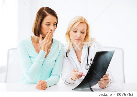 doctor with patient looking at x-ray doctor with patient looking at x-ray 8076762