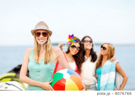 girl with ball and friends on the beach girl with ball and friends on the beach 8076766