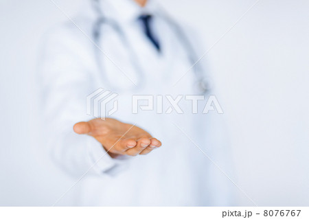 male doctor holding something in his hand male doctor holding something in his hand 8076767