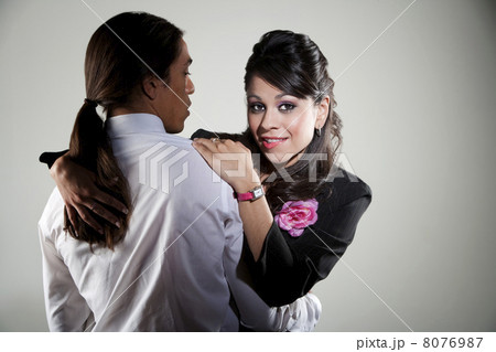 Mixed race professional man embracing Hispanic woman 8076987