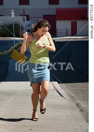 Woman is late and running. 8077018