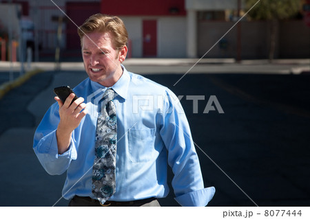 Upset, good-looking man angry with cell phone. 8077444