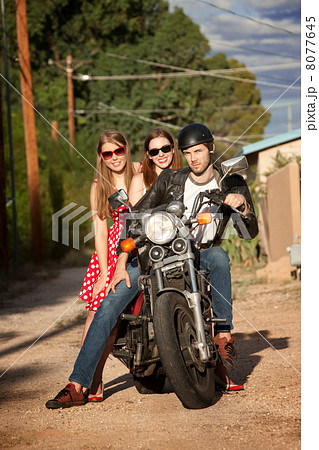 Trio posing on motorcycle Trio posing on motorcycle 8077645