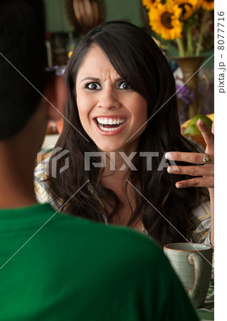 Angry Latina Woman with Cofee or Tea and Male Companion Angry Latina Woman with Cofee or Tea and Male Companion 8077716