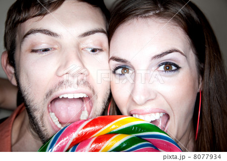 Couple Biting into Lollipop Couple Biting into Lollipop 8077934