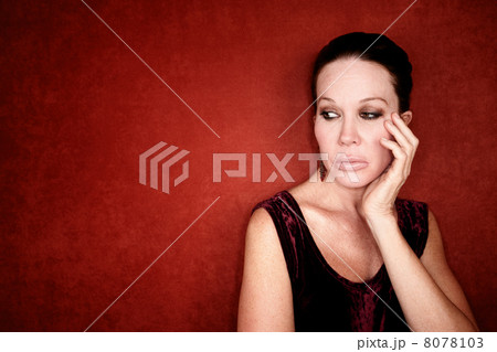 Apprehensive woman on red background 8078103
