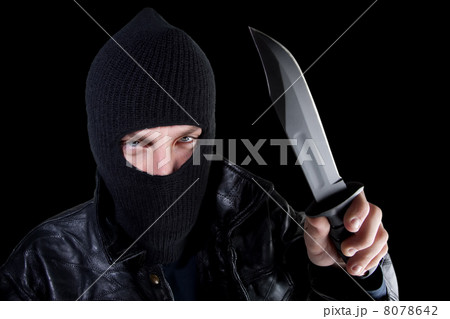 Man in mask with large knife on black Man in mask with large knife on black 8078642