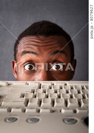 Surprised Eyes of Man Above Keyboard 8079627