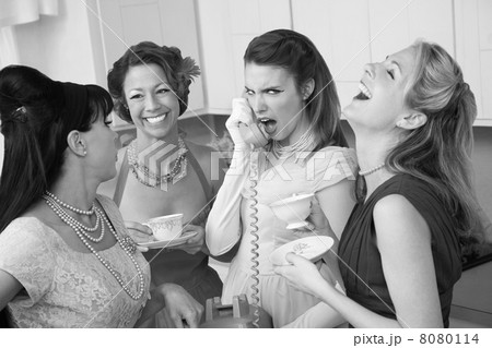 Woman Laughing at Friend on Phone 8080114