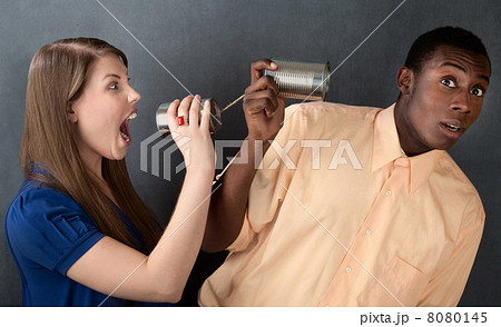 Woman Yelling at Man Through Stringed Cans Woman Yelling at Man Through Stringed Cans 8080145
