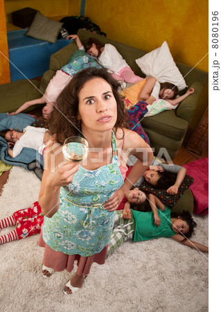 Woman with wine and girls at sleepover 8080196