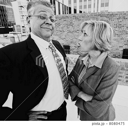 Woman sticking out her tongue at coworker or boss 8080475