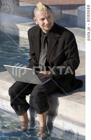 Punk Businessman with Feet in the Water Punk Businessman with Feet in the Water 8080688