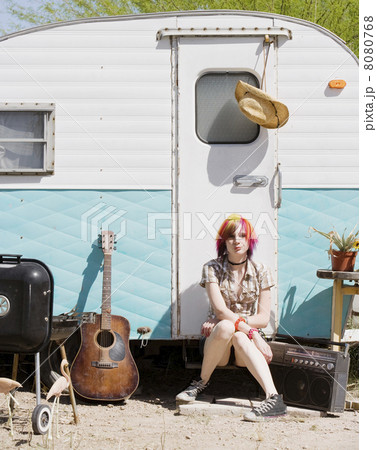 Girl Sitting on a Trailer Step 8080768