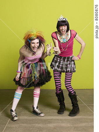 Young punk women linked by handcuffs 8080876