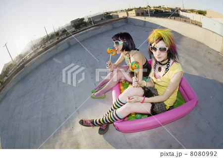 Girsl on a roof in a plastic pool 8080992