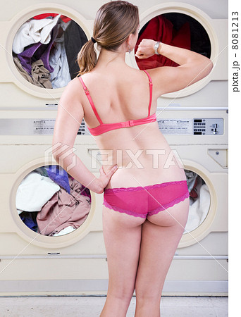 Pretty woman in underwear waiting for dryers to finish Pretty woman in underwear waiting for dryers to finish 8081213