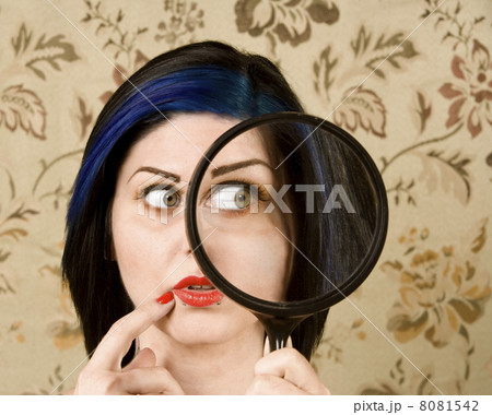 Pretty Woman with a Magnifying Glass 8081542