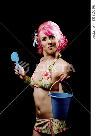 Woman in a bikini on black with pail and shovel 8082096