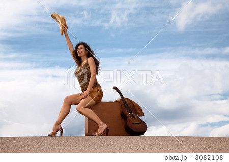 Pretty woman with suitcase and guitar Pretty woman with suitcase and guitar 8082108