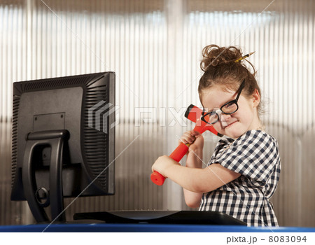 Nerdy girl smashing her computer 8083094