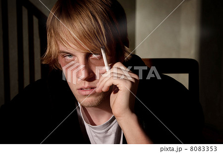 Depressed young man smoking Depressed young man smoking 8083353