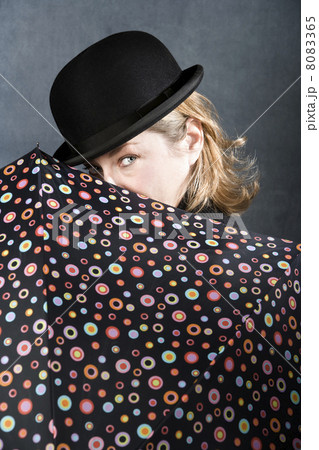 Woman in a bowler hat with umbrella Woman in a bowler hat with umbrella 8083365