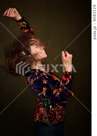 Dancing woman with long brunette hair and headphones 8083529