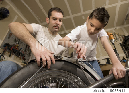 Father and son in garage 8083911