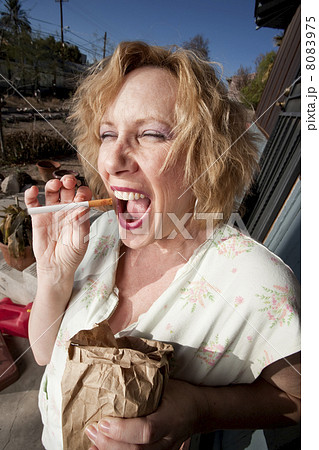 Smoking woman on her porch 8083975