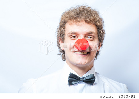 Young studen or Businessman with a red clown nose. Studio shot. Head and shoulders. Young studen or Businessman with a red clown nose. Studio shot. Head and shoulders. 8090791