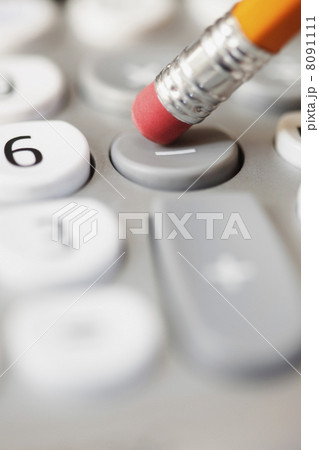 Pencil pushing subtraction button on calculator 8091111