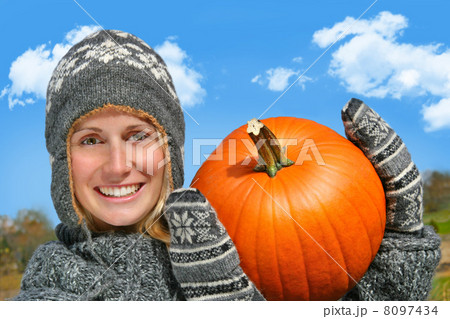 Young woman holding up a pumpkin Young woman holding up a pumpkin 8097434