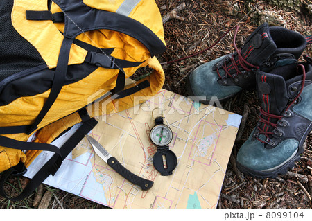Hiking shoes on map with compass Hiking shoes on map with compass 8099104