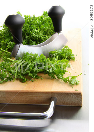 Freshly chopped parsley on wooden cutting 8099172