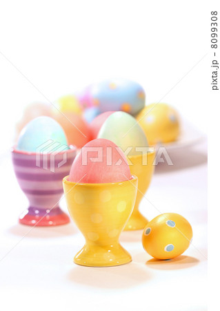 Egg cups with colored eggs on white Egg cups with colored eggs on white 8099308