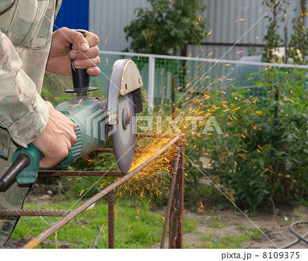 Angle Grinder Metal sawing with flashing sparks  handheld electric instrument 8109375